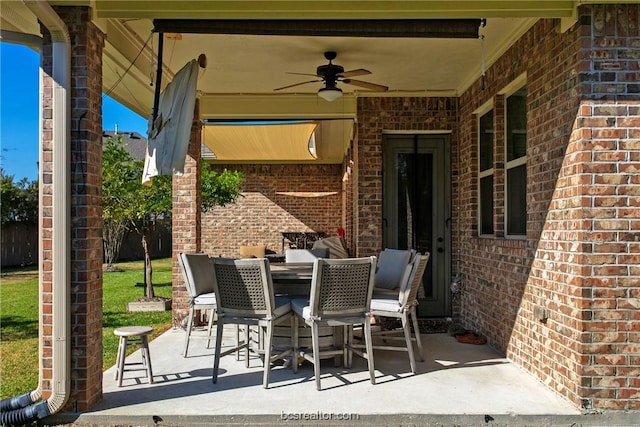 view of patio with outdoor dining area and ceiling fan