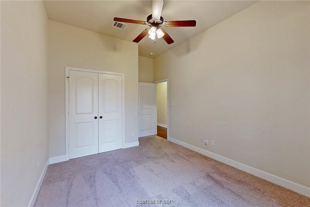 unfurnished bedroom featuring visible vents, baseboards, carpet, and a closet