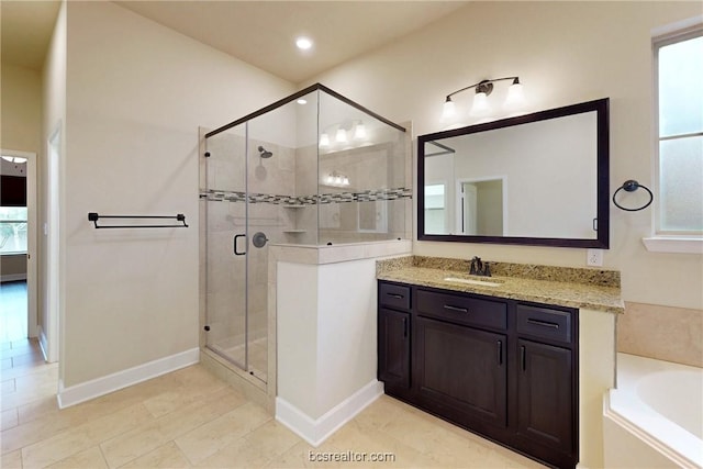 bathroom with baseboards, a garden tub, recessed lighting, a stall shower, and vanity