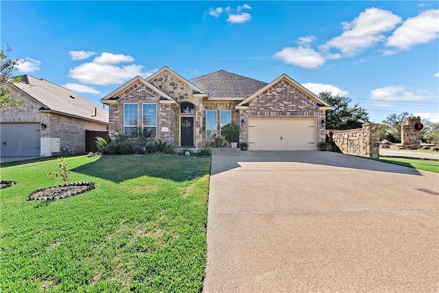 view of front of home with a garage and a front lawn