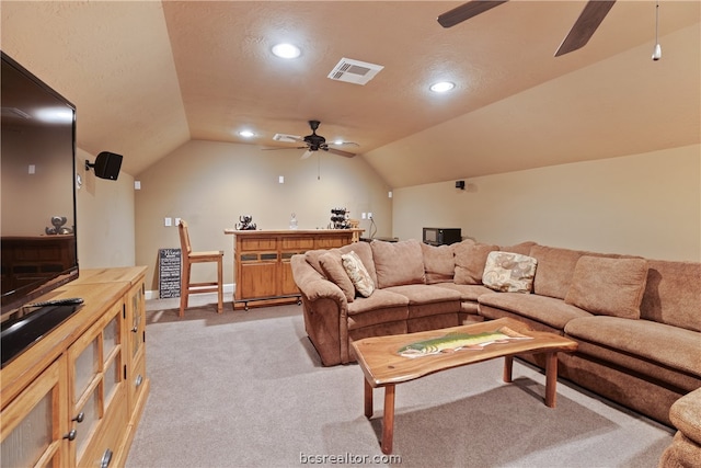 living room featuring a textured ceiling, ceiling fan, light colored carpet, and lofted ceiling