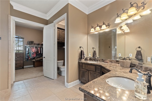 bathroom with vanity, toilet, and crown molding