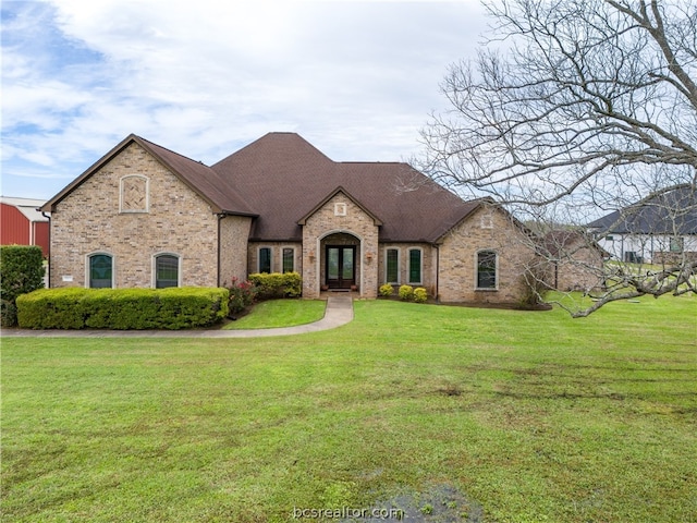 french country home with french doors and a front yard