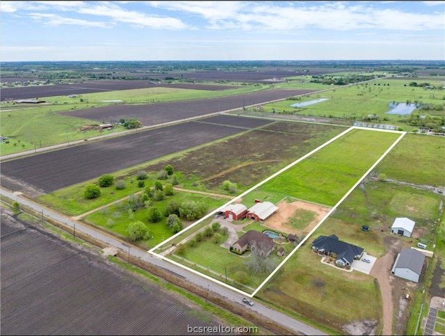 birds eye view of property featuring a water view and a rural view