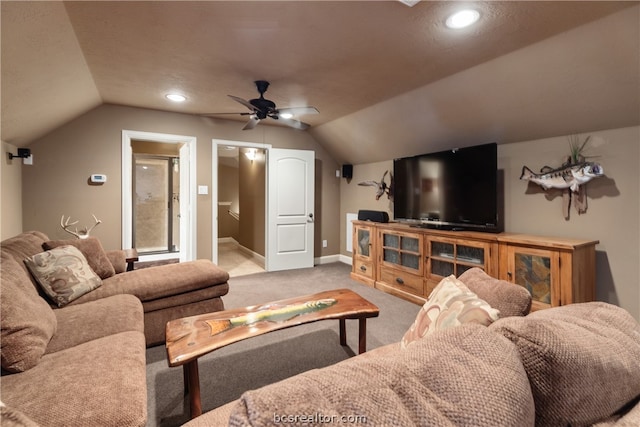 living room with carpet flooring, ceiling fan, a textured ceiling, and vaulted ceiling