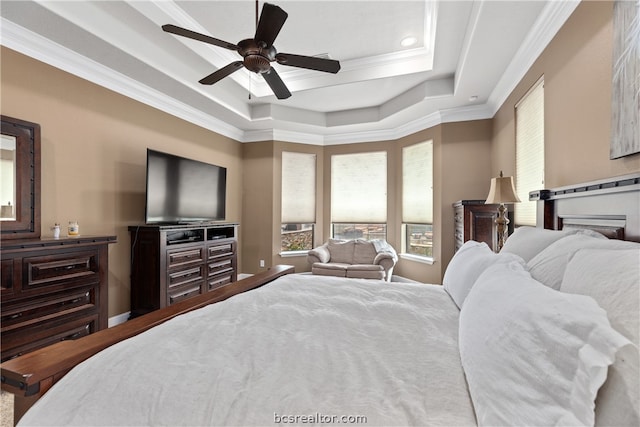 bedroom featuring ceiling fan, a raised ceiling, and crown molding