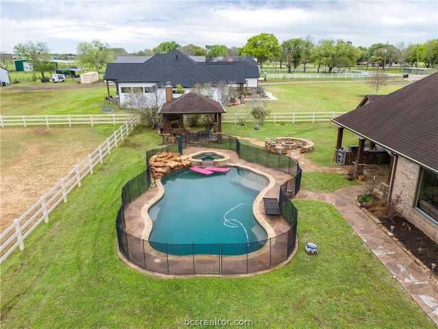 view of swimming pool with a gazebo, a rural view, and an outdoor fire pit