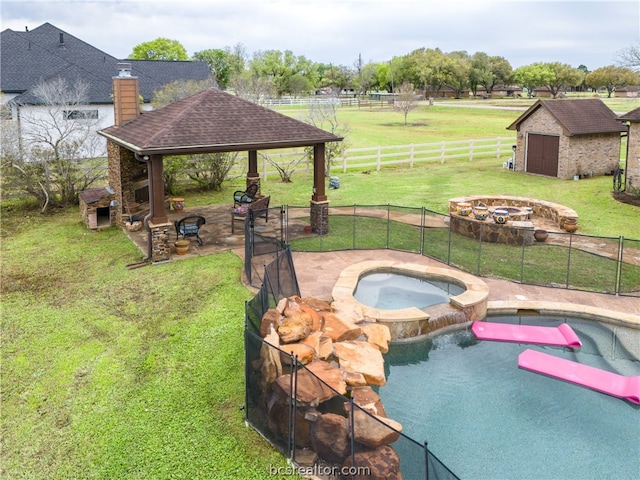 view of pool featuring an in ground hot tub, an outdoor structure, a gazebo, a rural view, and an outdoor fire pit