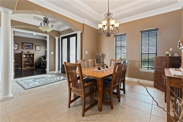 dining room featuring light tile patterned floors, decorative columns, ornamental molding, and a notable chandelier