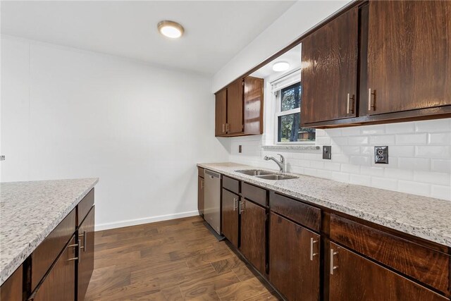 kitchen with backsplash, dark wood-type flooring, sink, stainless steel dishwasher, and dark brown cabinets