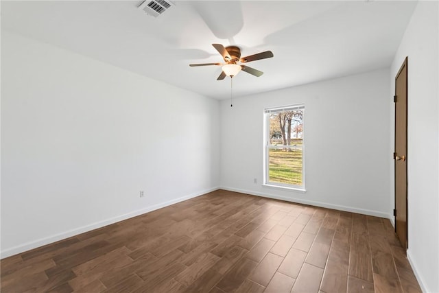 empty room with ceiling fan and dark hardwood / wood-style flooring