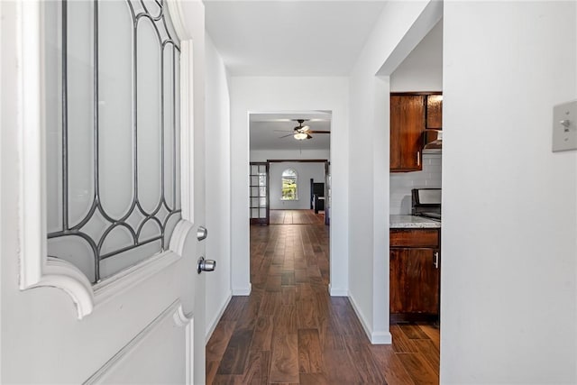 hallway with dark hardwood / wood-style flooring