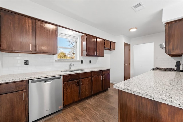 kitchen featuring sink, stainless steel dishwasher, dark hardwood / wood-style floors, stove, and decorative backsplash