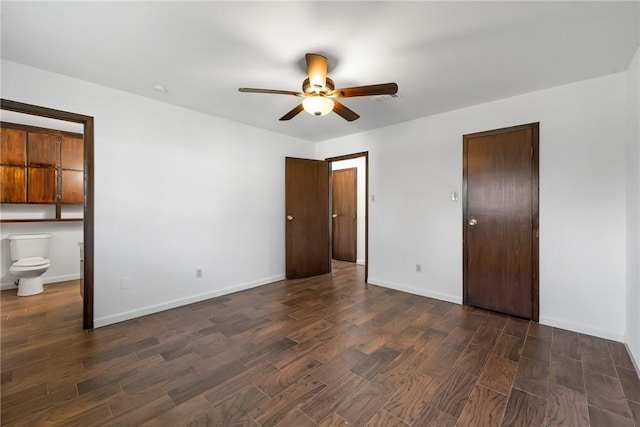 unfurnished bedroom with dark hardwood / wood-style flooring, ceiling fan, and connected bathroom