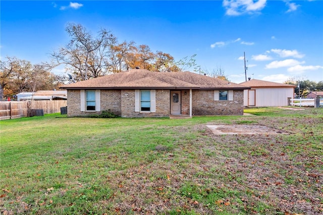 rear view of house featuring a lawn