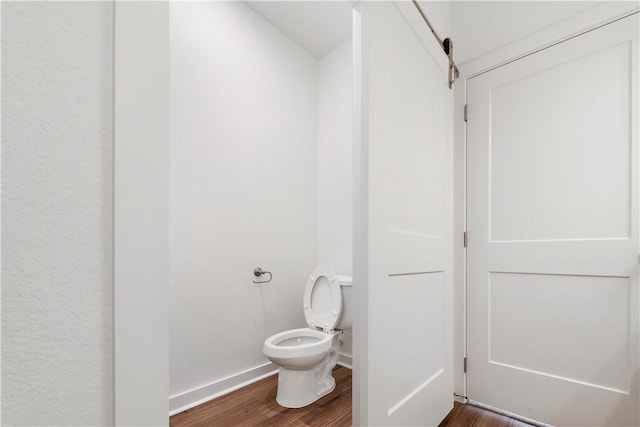 bathroom featuring toilet and hardwood / wood-style floors