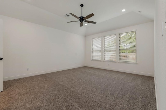 carpeted spare room featuring ceiling fan and vaulted ceiling