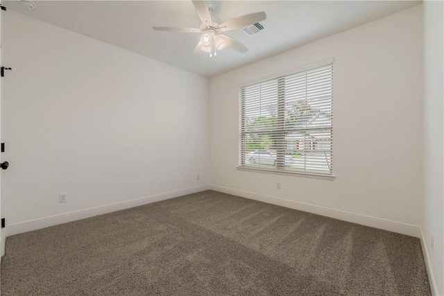 carpeted spare room featuring ceiling fan