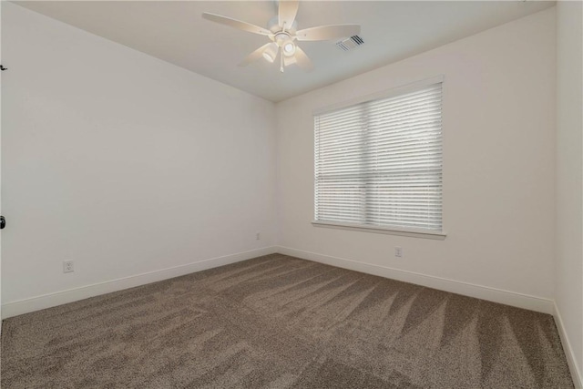 carpeted spare room featuring ceiling fan