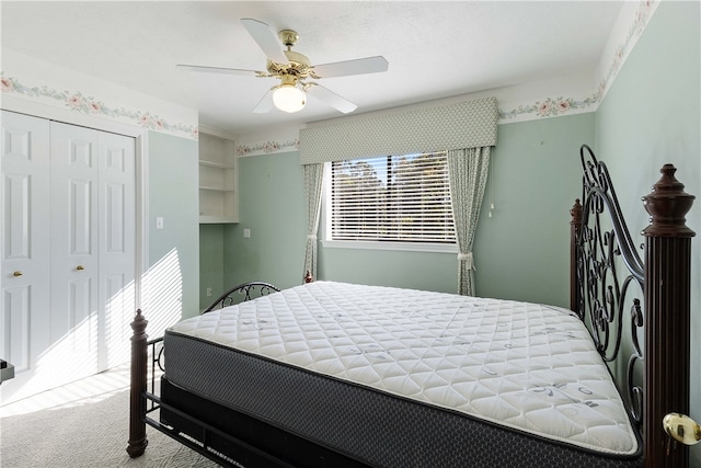 carpeted bedroom with ceiling fan and a closet