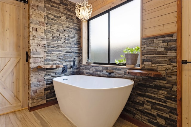 bathroom featuring hardwood / wood-style flooring and a washtub