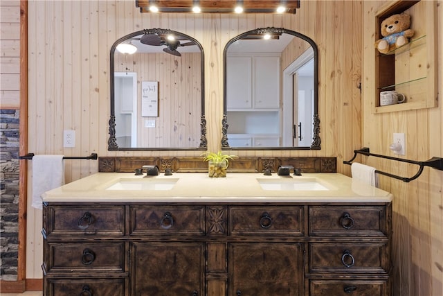 bathroom featuring vanity and wooden walls