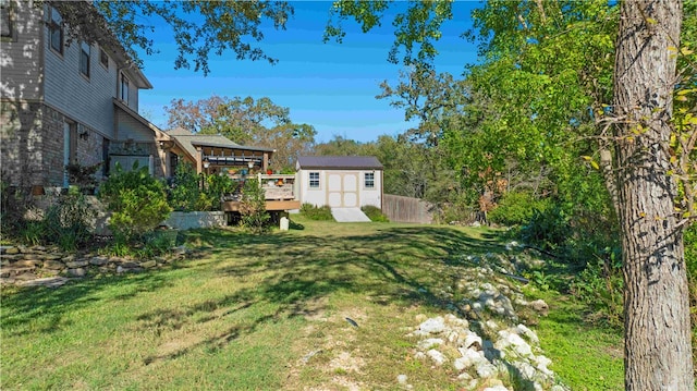 view of yard featuring a deck and a shed