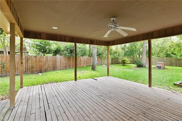 wooden deck with ceiling fan and a lawn