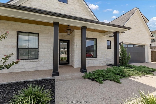 doorway to property featuring a porch and a garage