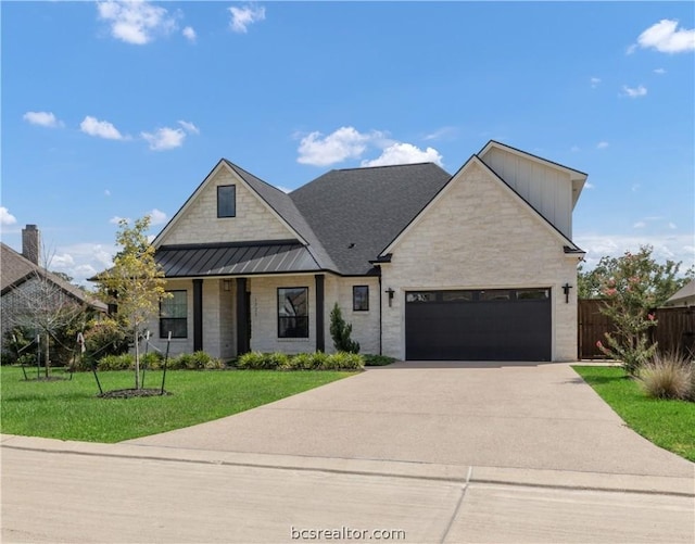 view of front of house featuring a garage and a front lawn