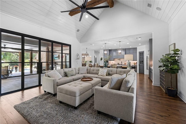 living area featuring high vaulted ceiling, ceiling fan, and dark wood finished floors
