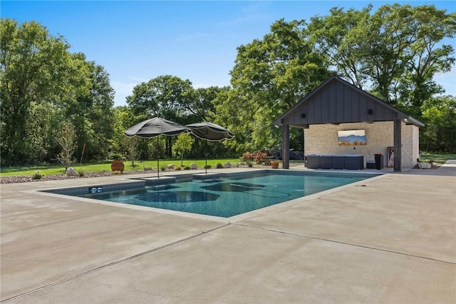 pool with a patio and a lawn