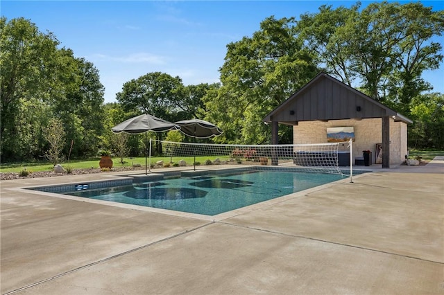 pool with a patio area and fence