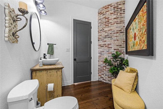 bathroom featuring toilet, wood finished floors, and vanity