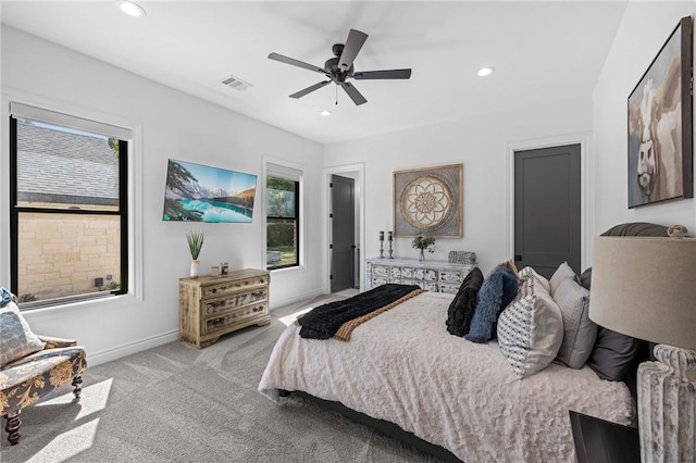 bedroom featuring recessed lighting, carpet, visible vents, and multiple windows
