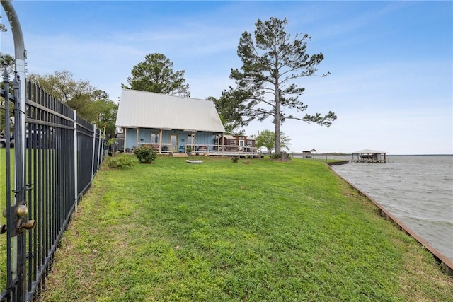 view of yard with fence and a water view