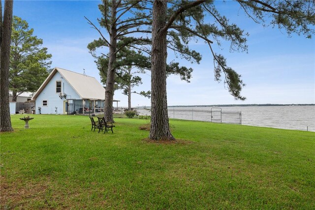 view of yard featuring a water view and fence