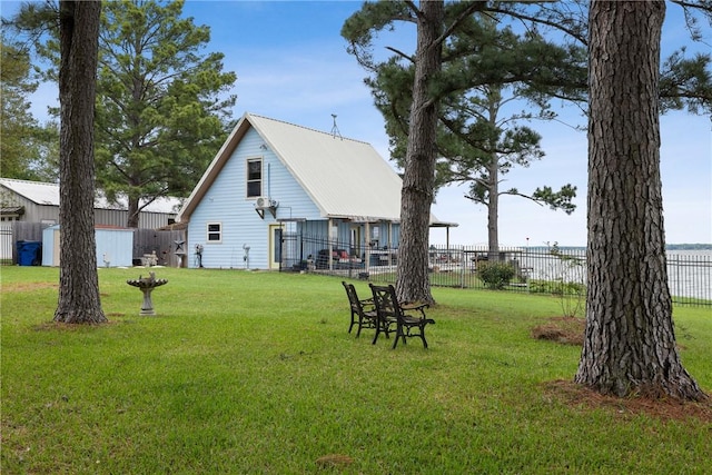 view of yard with a storage shed, fence, and an outdoor structure