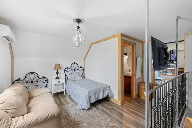 bedroom with a wall unit AC, wood finished floors, and lofted ceiling
