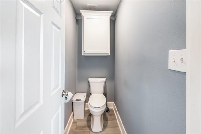 bathroom featuring hardwood / wood-style flooring and toilet