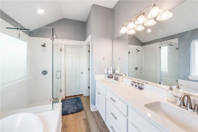 bathroom with separate shower and tub, hardwood / wood-style floors, vanity, and lofted ceiling