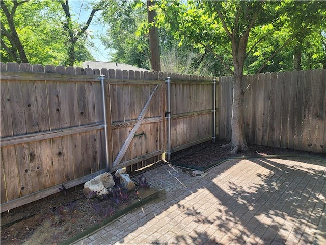 view of gate with a patio area