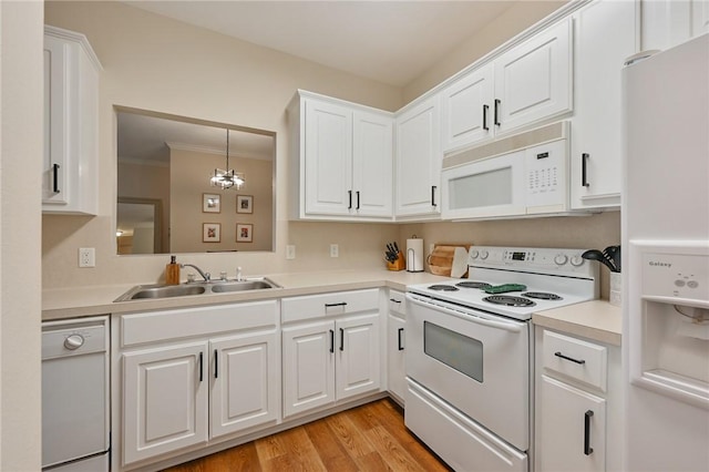 kitchen with sink, white cabinets, white appliances, and light wood-type flooring