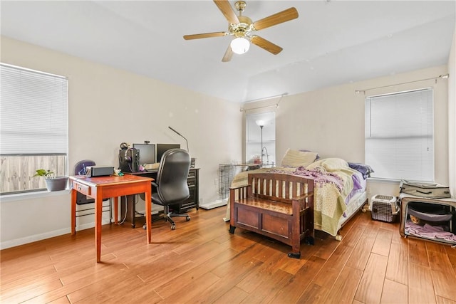 bedroom featuring wood finished floors, a ceiling fan, and vaulted ceiling