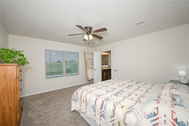 817 Mockingbird St, Navasota, TX 77868 - carpeted bedroom with baseboards, a ceiling fan, and connected bathroom