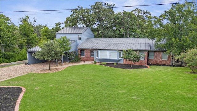 3907 Nagle St N, Bryan, TX 77801 - view of front of house with brick siding, a front lawn, and a metal roof