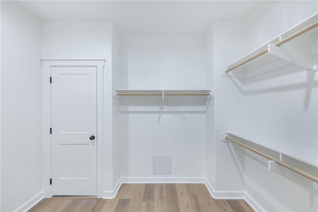 walk in closet featuring light hardwood / wood-style flooring