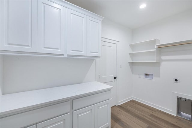 washroom featuring washer hookup, cabinets, dark hardwood / wood-style floors, and hookup for an electric dryer