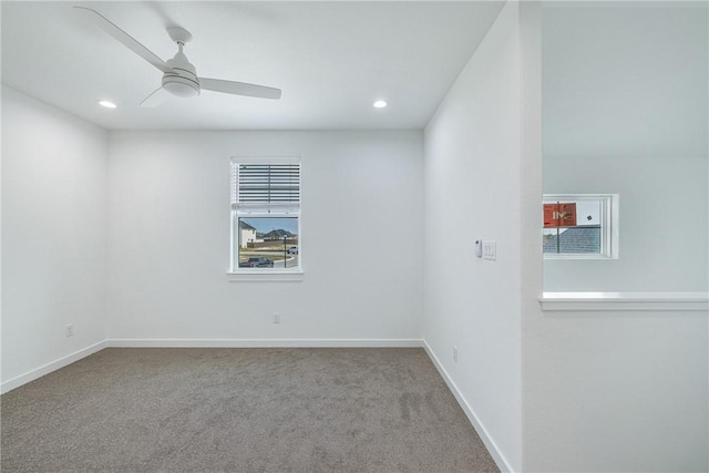 spare room with carpet and ceiling fan