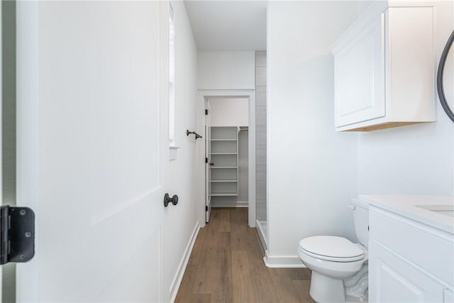 bathroom featuring toilet, vanity, and hardwood / wood-style flooring